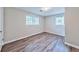 Bright bedroom featuring wood-look floors, neutral paint, and natural light through windows at 5666 Goldfield Dr, Acworth, GA 30102