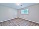 Cozy bedroom showcasing wood-look floors and a window allowing natural light at 5666 Goldfield Dr, Acworth, GA 30102