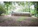 Rear exterior view of the brick house, featuring a spacious backyard at 5666 Goldfield Dr, Acworth, GA 30102