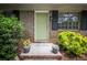 Inviting front entrance with a freshly painted green door, brick steps and potted plants at 5666 Goldfield Dr, Acworth, GA 30102