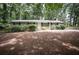 Ranch style home with brick exterior, green door, manicured front yard with mature trees and shrubs at 5666 Goldfield Dr, Acworth, GA 30102