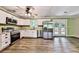 Updated kitchen features white cabinets, stainless steel appliances, granite countertops, and vinyl plank floors at 5666 Goldfield Dr, Acworth, GA 30102