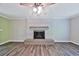 Cozy living room with a brick fireplace, mantle and stylish vinyl plank flooring at 5666 Goldfield Dr, Acworth, GA 30102