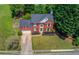 Beautiful aerial view of a two-story brick home showcasing the manicured lawn and mature trees at 1370 Stoney Field Place, Lawrenceville, GA 30043