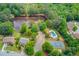 Community amenities with pool, tennis court, and lake surrounded by lush green trees at 1370 Stoney Field Place, Lawrenceville, GA 30043