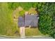 Aerial view showcasing the home's backyard, patio, lush trees and well-maintained lawn at 1370 Stoney Field Place, Lawrenceville, GA 30043