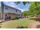 Expansive backyard with a large deck, patio seating, play set, and mature trees at 1370 Stoney Field Place, Lawrenceville, GA 30043