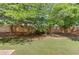 Expansive backyard with a well-maintained lawn and a sturdy wooden fence at 1370 Stoney Field Place, Lawrenceville, GA 30043