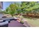 Spacious backyard featuring a patio area, lounge seating, and a swing set for fun at 1370 Stoney Field Place, Lawrenceville, GA 30043