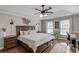 Comfortable bedroom featuring a ceiling fan, hardwood floors, and natural light at 1370 Stoney Field Place, Lawrenceville, GA 30043