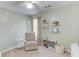 Charming bedroom with daisy wall decals, comfortable chair, and shelves at 1370 Stoney Field Place, Lawrenceville, GA 30043