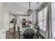 Open floorplan showcasing the dining area adjacent to a kitchen featuring stainless appliances and white cabinetry at 1370 Stoney Field Place, Lawrenceville, GA 30043