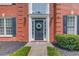 Charming red brick home with a classic black door, white trim, and manicured landscaping offers great curb appeal at 1370 Stoney Field Place, Lawrenceville, GA 30043