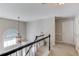 Bright hallway area with decorative window, staircase and neutral decor at 1370 Stoney Field Place, Lawrenceville, GA 30043