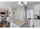 View of kitchen island and open-concept layout leading to the living room with fireplace at 1370 Stoney Field Place, Lawrenceville, GA 30043