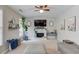 Comfortable living room with fireplace, ceiling fan, large window, and neutral decor at 1370 Stoney Field Place, Lawrenceville, GA 30043