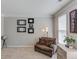 Cozy living room with neutral colors, plush chair, and natural light provides a comfortable retreat at 1370 Stoney Field Place, Lawrenceville, GA 30043