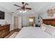Beautiful main bedroom features tray ceiling, ceiling fan and ensuite bath access at 1370 Stoney Field Place, Lawrenceville, GA 30043
