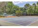 Well-maintained community tennis court with nearby pool and seating area provides great recreational opportunities at 1370 Stoney Field Place, Lawrenceville, GA 30043