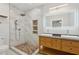 Bathroom with dual sinks, marble tiled shower, rain shower head, and vanity at 1667 Sylvan Sw Rd, Atlanta, GA 30310