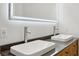 Bathroom featuring double sinks, lighted mirror, and wood vanity at 1667 Sylvan Sw Rd, Atlanta, GA 30310