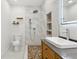 Bathroom featuring vanity, lighted mirror, and tiled shower at 1667 Sylvan Sw Rd, Atlanta, GA 30310