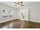 Bedroom featuring hardwood floors, neutral walls, and connecting bathroom at 1667 Sylvan Sw Rd, Atlanta, GA 30310