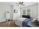 Comfortable bedroom with hardwood floors, a ceiling fan, a large mirror, and natural light at 1667 Sylvan Sw Rd, Atlanta, GA 30310