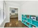 Hallway leading to a living room with hardwood floors and a blue bookshelf at 1667 Sylvan Sw Rd, Atlanta, GA 30310