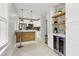 Modern kitchen features stainless steel appliances, wine cooler, breakfast bar, and floating shelves at 1667 Sylvan Sw Rd, Atlanta, GA 30310