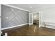 Stylish living room featuring unique wall decor, hardwood floors, and open doorway to Gathering room at 1667 Sylvan Sw Rd, Atlanta, GA 30310