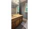Bathroom featuring a tiled shower, wood vanity, and natural light from the window at 2859 Wood Park Nw Trce, Kennesaw, GA 30152