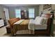 Bedroom featuring a wooden bed frame, dresser, and windows for natural light at 2859 Wood Park Nw Trce, Kennesaw, GA 30152
