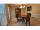 Cozy dining room featuring a wooden table and chairs set, complemented by natural light and a china cabinet at 2859 Wood Park Nw Trce, Kennesaw, GA 30152