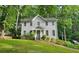 Charming two-story home with grey siding and a well-maintained front yard surrounded by lush trees at 2859 Wood Park Nw Trce, Kennesaw, GA 30152