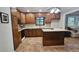Cozy kitchen with wood cabinets, island, and view into the backyard at 2859 Wood Park Nw Trce, Kennesaw, GA 30152