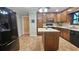 Traditional kitchen featuring wood cabinets, island with white countertop, and modern black appliances at 2859 Wood Park Nw Trce, Kennesaw, GA 30152