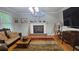 Cozy living room with hardwood floors, fireplace, unique decor, and natural light at 2859 Wood Park Nw Trce, Kennesaw, GA 30152