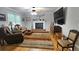 Inviting living room with hardwood floors, fireplace, comfortable seating, and a large TV at 2859 Wood Park Nw Trce, Kennesaw, GA 30152