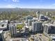 An aerial view of the city, highlighting the skyline and its many trees at 325 E Paces Ferry Rd # 2003, Atlanta, GA 30305