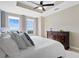 Bright bedroom features a tray ceiling, fan, natural light, and dark wood dresser at 325 E Paces Ferry Rd # 2003, Atlanta, GA 30305