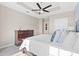 Bedroom features a tray ceiling, ceiling fan, dark wood furnishings and a view of the bathroom at 325 E Paces Ferry Rd # 2003, Atlanta, GA 30305