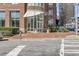 Building entrance featuring canopy, landscaped planters, and sidewalk access at 325 E Paces Ferry Rd # 2003, Atlanta, GA 30305