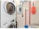 Laundry area features a stacked washer and dryer, storage, and laundry organization at 325 E Paces Ferry Rd # 2003, Atlanta, GA 30305