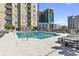 Relaxing outdoor pool area with plenty of lounge chairs, set against a backdrop of stunning city skyline views at 325 E Paces Ferry Rd # 2003, Atlanta, GA 30305