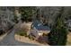 An aerial view shows the house surrounded by greenery and a long driveway at 5270 Forest Brook Pkwy, Marietta, GA 30068