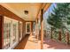 Inviting back porch with brick exterior, wooden floors, and natural sunlight at 5270 Forest Brook Pkwy, Marietta, GA 30068