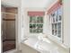 Bathroom showcasing a soaking tub under windows and separate glass-enclosed shower at 5270 Forest Brook Pkwy, Marietta, GA 30068