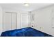 Bedroom with blue carpet, white walls, closet doors, and natural light from window at 5270 Forest Brook Pkwy, Marietta, GA 30068