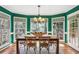 Elegant dining room showcasing a wooden table, six chairs, and large windows for natural light at 5270 Forest Brook Pkwy, Marietta, GA 30068
